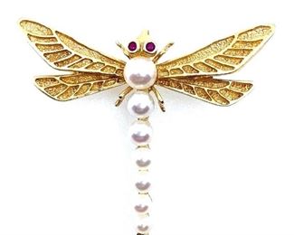 Wonderful 14K yellow gold brooch in the form of a dragonfly with 7 graduated cultured pearls forming the body and two small round ruby eyes. 6gms. Length: 1.25 in Condition: Very fine
