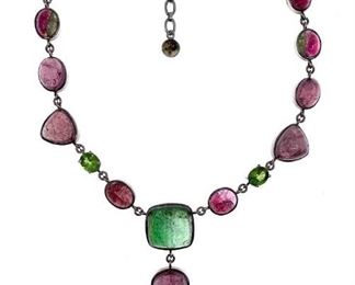 Seventeen bead drop necklace with pink and green tourmalines, with two faceted green tourmalines, the others cabochon, signed with Lilia Lopez tag. 91g. 18 in.l. Condition: Very good.
