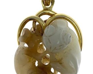 The jade carved as two conjoined cats in a looped gold mount. 2 in.l. 21 g.
