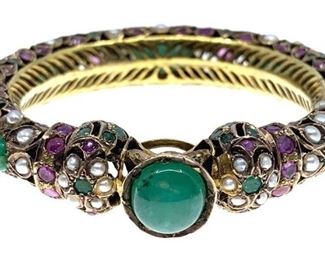 Indian Gold Emerald Pink Sapphire and Pearl Bracelet. Openwork gold bangle bracelet with cabochon emerald clasp, fashioned with flower heads of cabochon emeralds and natural pearls, with pink sapphires in between. Unmarked, presumed to be 14K. 2 1/8 in. int. dia. 80 g.