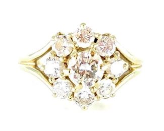 Ladies Diamond Ring. 14K yellow gold ring set with eight small bright white diamonds around a larger center stone, all prong set, approx 4 grams, approx size 5.5. Condition: very nice. Needs to be cleaned, visible inclusions.