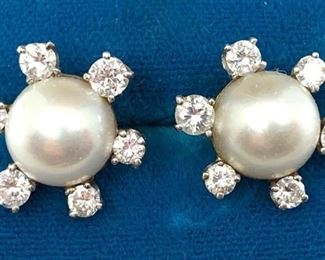 Pair of Diamond and Mabe Pearl Earrings. Approx 15.8750mm Mabe pearls surrounded by six white prong set diamonds, approx 1/2"D. Presumed white gold, unmarked, approx 4gms. Post backs for pierced ears.