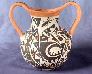 Acoma Pottery Two Handled Jar, P.Ivle. Acoma Pottery Two Handled Jar, P.Ivle, spherical form with applied handles, decorated in polychrome slip glaze with stylized animals birds, fish and insects ina geometric pattern, signed P.Ivle, Acoma, N.M.  7 in.h.  Condition: Very good