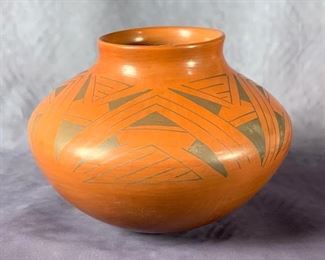 Native American Pottery Jar. Native American Pottery Jar, burnished terracotta with black slip glaze geometric decoration, unsigned.  6 in. h x 7.5 in. w.  Condition: minor expected oxidation/wear.
