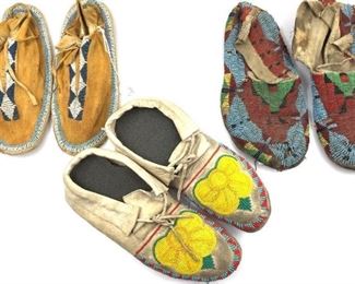 Three Pairs of Native American Beaded Hide Moccasins Pair of Native American Beaded Hide Moccasins, side sewn with rawhide sole, beaded with turquoise, red, green, blue and yellow in a geometric pattern, together with a pair of Native American leather and beaded moccasins, blue and white geometric bead design to top and around base of top; and a floral beaded pair with yellow floral designs with turquoise, red and green.  Provenance: Private Collection. Cleveland, Ohio, purchased from Estate of Dorothy Louise Luhrs, PhD, (1910-1972), Archaeologist with University of New Mexico/School of American Research Field School, whose studies and research included the Una Via Chaco Canyon, NM, Largo Canyon, NM, Guatemala, Mexico, and the Hoopa Indian Reservation in northern California. Luhrs was also president of the Southwestern Anthropological Association from 1950-51.  10 in. l. , 9 in. l. 9.5 in. l.  Condition: the 1st with splits at side seams on both, dusty, brittle, losses, tears. 2nd, sta