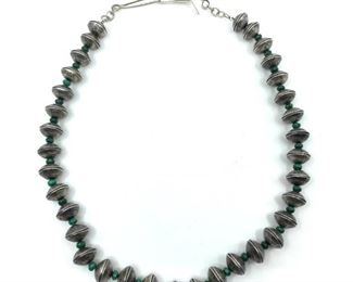 Navajo Mercury Winged Liberty Head Dime Necklace. Navajo Mercury Winged Liberty Head Dime Necklace, fashioned as pairs of curved confronting liberty head dimes forming each bead, 1930's-40's coins, with malachite bead spacers.  24 in. total l. including clasps