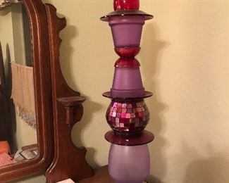 She calls it yard art. We have several made out of antique glass of many colors