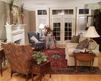 In the living room are two beautiful wing back chairs and sofa