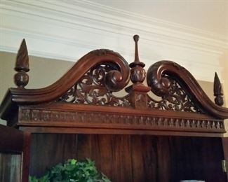 A close look at the secretary's pediment and finials