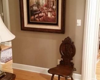 Antique Italian hand carved hall chair and large oil painting of a piano room
