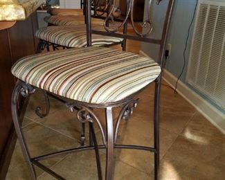 Four wrought iron bar chairs with upholstered seats