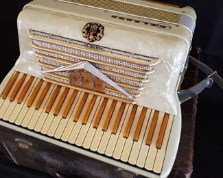 Antique accordion, with lizard embossed leather case