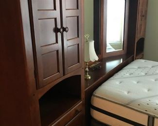 Closeup of cabinet and bed.