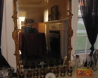 Gilt mirror, Name Your Poison highball glasses by Georges Briard, Skull swizzle sticks