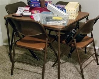 There are 2 card Card Tables with 4 chairs each (there are also two unmatched folding chairs)