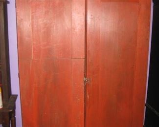 Vintage red cabinet. One door has been cut in two pieces like a Dutch door