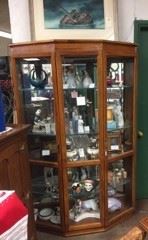 A display cabinet with lots of miscellaneous items.