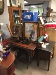 A treadle sewing machine with more stuff.