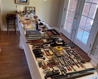 Tables full of Colt collectibles, knives, pins, badges, etc