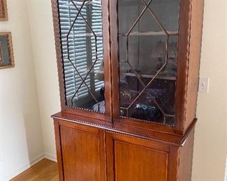 Antique A George III Mahogany and Satinwood Bookcase with Soxwood and Ebony Striping. The base being a two door cupboard and surronded by a pair of 13 panel glass doors. Circa 1790