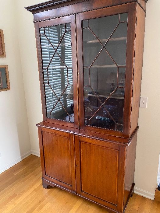 Antique A George III Mahogany and Satinwood Bookcase with Soxwood and Ebony Striping. The base being a two door cupboard and surronded by a pair of 13 panel glass doors. Circa 1790