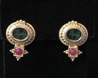 Green intaglio cut glass set in 14kt gold with ruby cabachons. Pierced earrings.