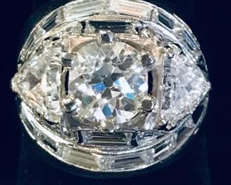 This ring is a custom  Art Deco  diamond and 14kt white gold ring set atop a  gold band.Center diamond is 1.31 carats. The 2 triangular diamonds are 0.75 carats each. Total carat weight approx. 4.04 carats.