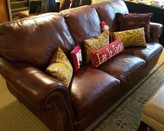 Leather three-cushion sofa.  Does show some wear, but still looks great and quite comfortable!