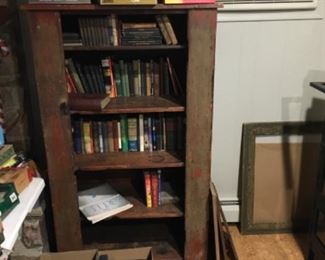 Some of the books being sold (there are hundreds not yet pictured, cupboard/shelf not for sale), antique picture frames