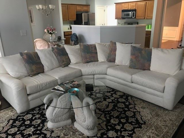 White sectional with throw pillows.  Excellent condition. Comes with extra white pillow.