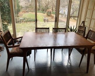 Drexel walnut table with 3 leaves and 4 chairs, 1 chair missing 1 small vertical back dowel 