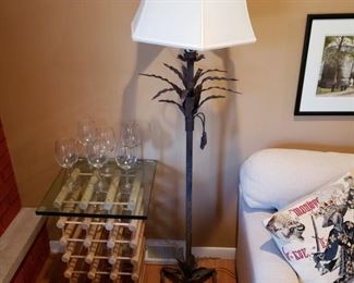 Metal palm tree floor lamp and a wine rack with glasses