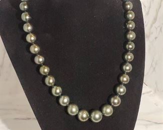 CULTURED TAHITIAN PEARL NECKLACE. Individually hand knotted. Finished with 14K white Gold Plunger Style Bead Clasp. Measures 17.5inches in length. 
Round in shape.
Excellent luster. 
Estimated Retail Replacement value: $11,600.00
Minimum Reserved Bid: $700.00
