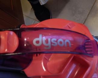 Dyson vacuum cleaner with attachments.