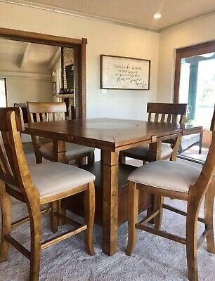 Haverty's Sonoma Valley Gathering Table with six (6) Slat Back Barstools
•	Gathering Table 46" x 46" x 36", expandable to 60" round x 36"
•	QTY of six (6) 24" Slat Back Barstool 20" x 18" x 42"
