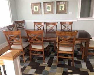 Upscale dining table and chairs; table is shown with two leaves in place
