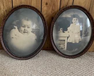 Antique photos in curved glass frames.