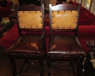 2 bar stools also finished in leather.