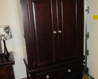 The armoire that matches the master bedroom suite of furniture.