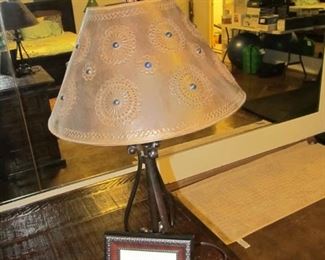 Wrought-iron desk lamp with a custom metal shade that has blue glass beadwork.
