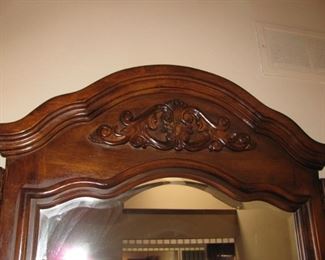 Close up of the carved wood detail on dresser mirror
