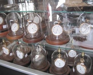 Dozens of Antique Pocket Watches with individual Glass Dust Domes.