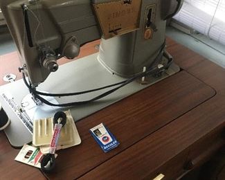 Singer sewing machine 
In mid century cabinet