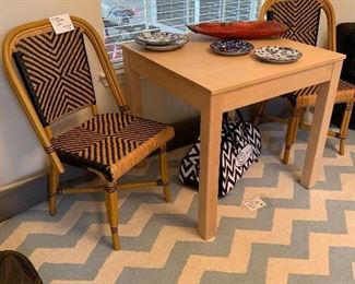 Pottery Barn Chevron 8’x10’ rug. Occasional table with rattan and navy chairs. 