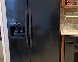 Black Whirlpool side by side Refrigerator. 