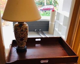 Butler's Taray table on a stand along with a Japanese porcelain lamp