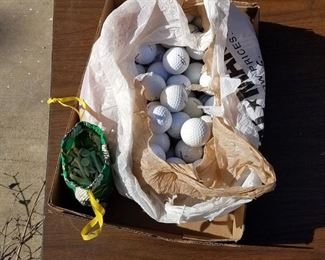 assorted golf balls and tees