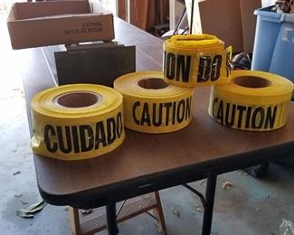 three rolls of caution tape and small roll of caution do not enter