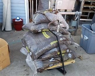 6 bags of mulch on broken garden Wagon