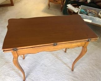 c.1950 Card Table  that can seat 4 and then converts to half size and into  console table fitting up nicely against a wall.  Has Secret compartment holds games and playing cards.   $75.00 Branded California Furniture Shop Ltd. 